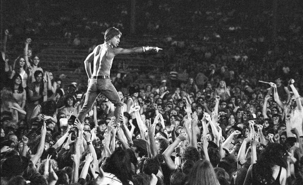 CINCINNATI - JUNE 23: Iggy Pop of the Stooges rides the crowd during a concert at Crosley Field on June 23, 1970 in Cincinnati, Ohio. (Photo by Tom Copi/Michael Ochs Archive/Getty Images)
